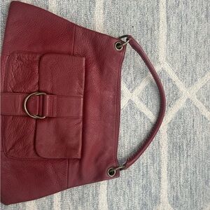 HOBO Red Leather Shoulder Bag with Adjustable Straps and Metal Accents